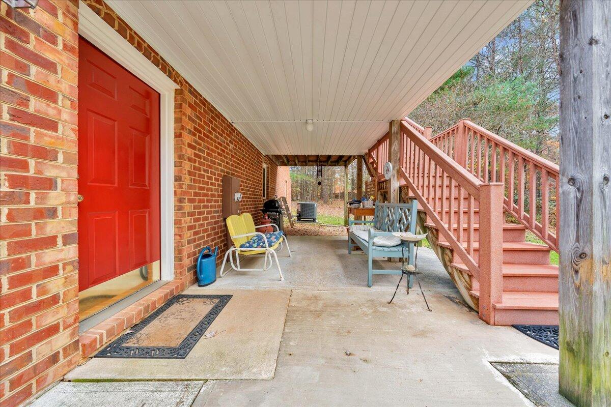 204 Raintree Lane Boones Mill, VA 24065 - Photo 35 of 58 a view of a patio with table and chairs with wooden floor and fence