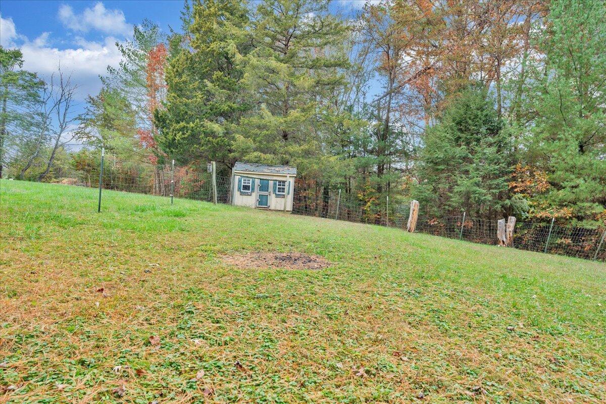 204 Raintree Lane Boones Mill, VA 24065 - Photo 41 of 58 a view of a yard with a house in the background