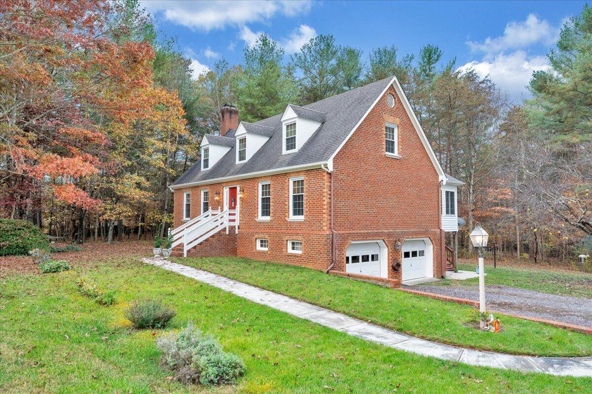 204 Raintree Lane Boones Mill, VA 24065 - Photo 50 of 58 a front view of a house with garden