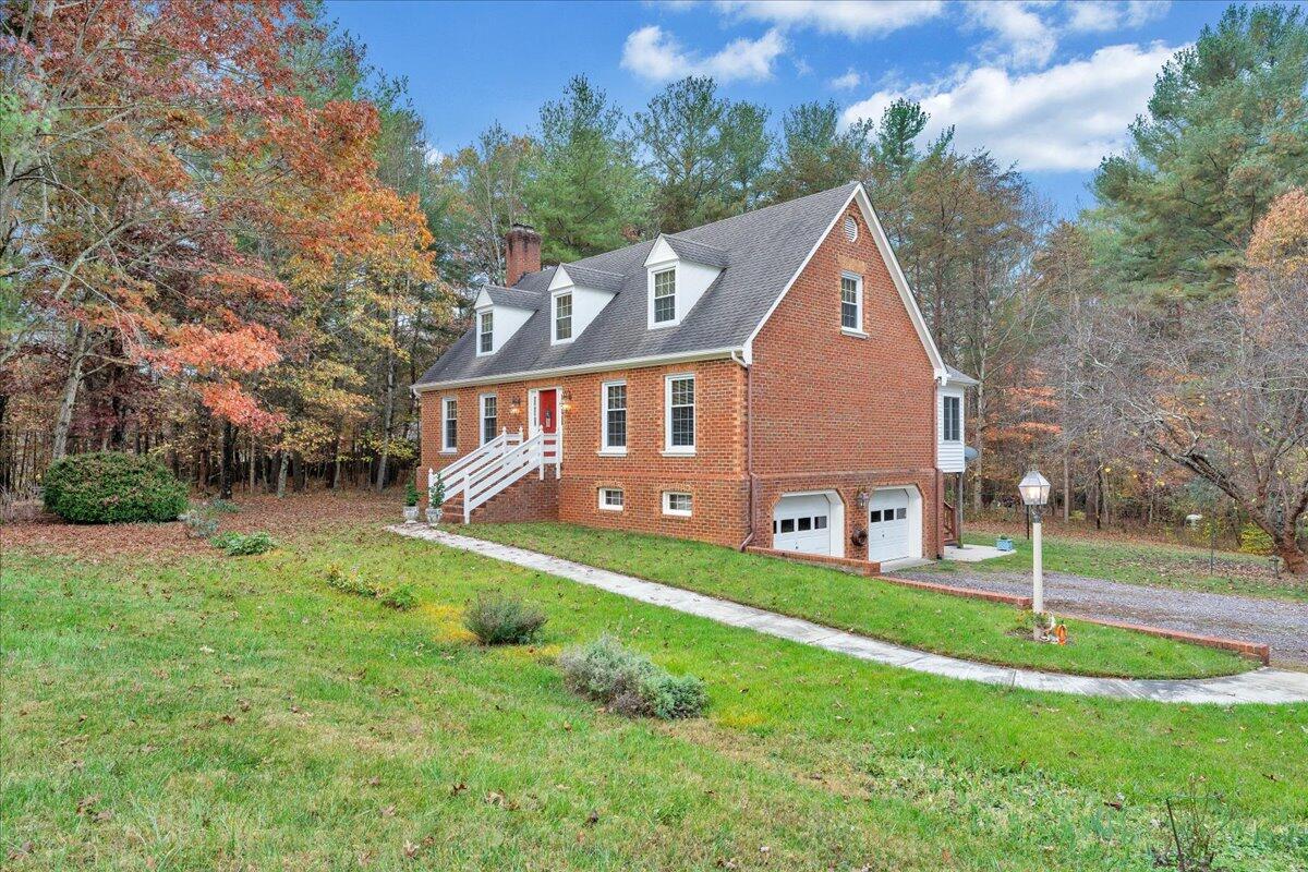 204 Raintree Lane Boones Mill, VA 24065 - Photo 51 of 58 a front view of a house with a yard and trees