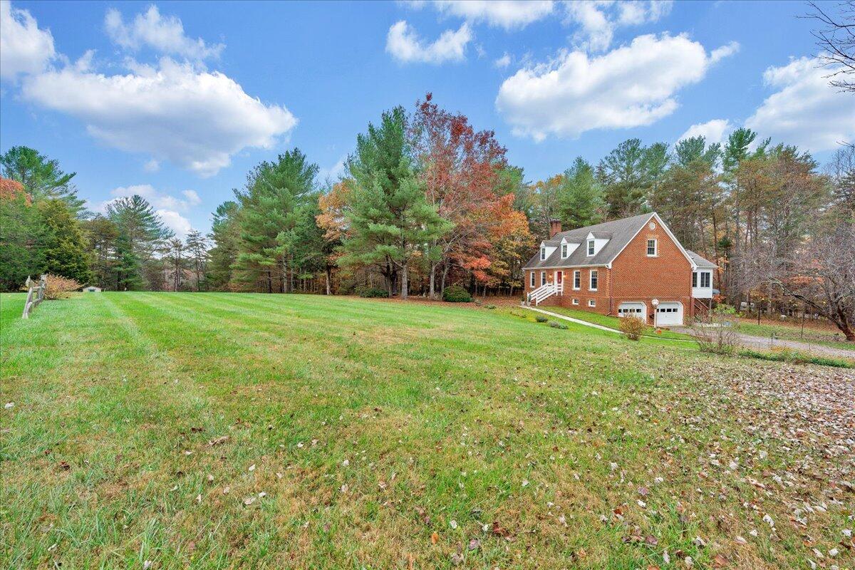204 Raintree Lane Boones Mill, VA 24065 - Photo 53 of 58 a backyard of a house with table and chairs