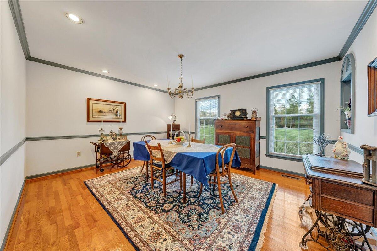 204 Raintree Lane Boones Mill, VA 24065 - Photo 6 of 58 a view of a dining room with furniture window and wooden floor