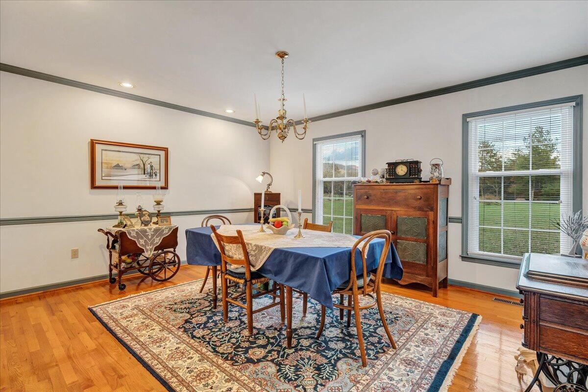 204 Raintree Lane Boones Mill, VA 24065 - Photo 7 of 58 a view of a dining room with furniture window and wooden floor