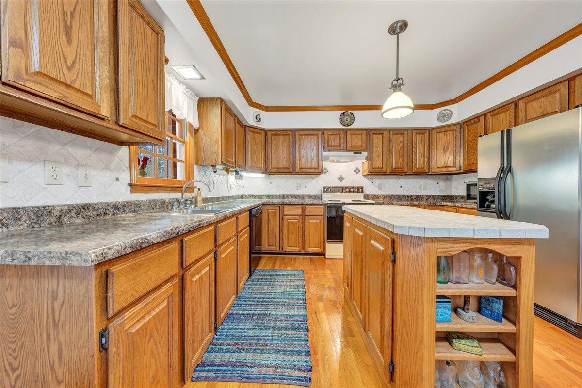 204 Raintree Lane Boones Mill, VA 24065 - Photo 10 of 58 a kitchen with stainless steel appliances granite countertop a sink a stove and a refrigerator