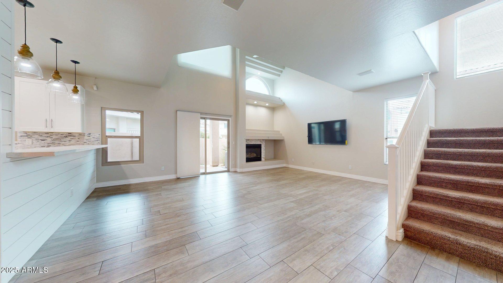 6510 South Hazelton Lane, Unit 142 Tempe, AZ 85283 - Photo 14 of 49 an empty room with wooden floor and windows