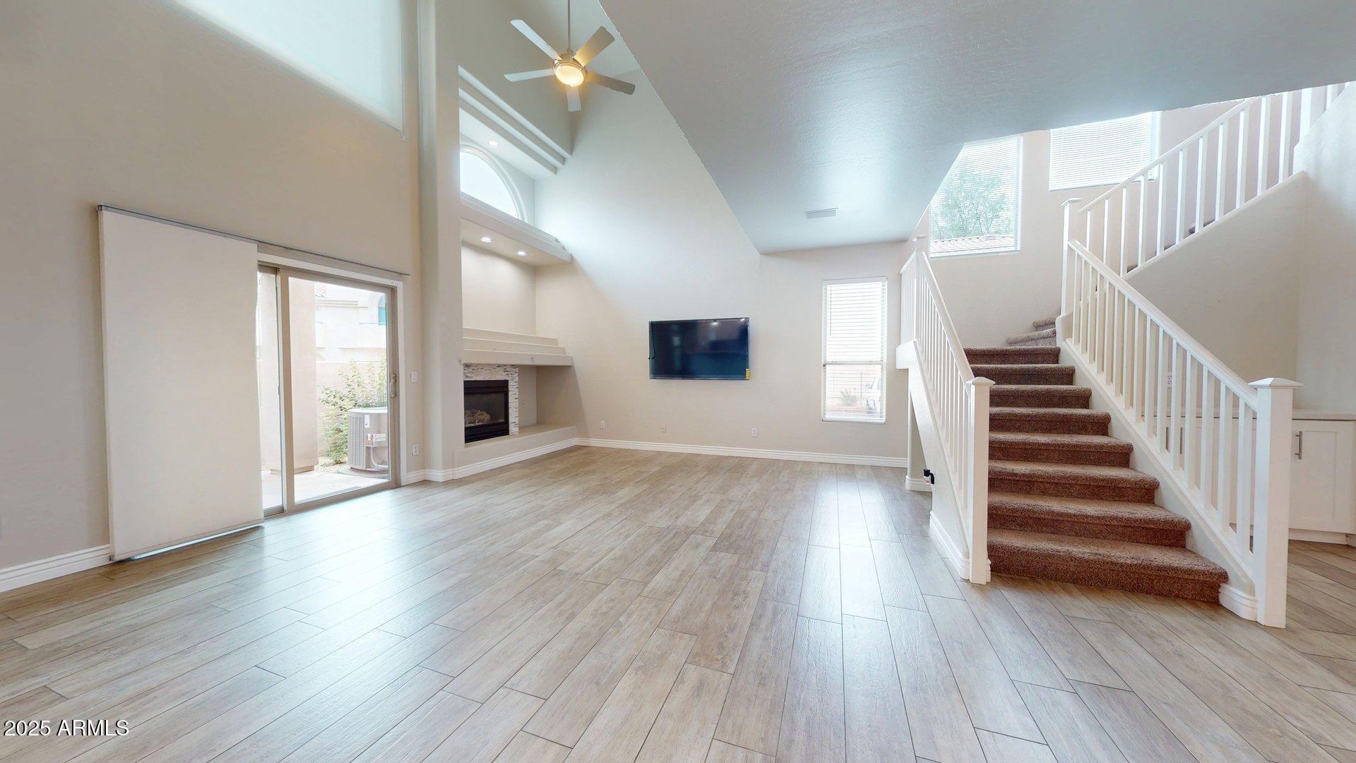 6510 South Hazelton Lane, Unit 142 Tempe, AZ 85283 - Photo 15 of 49 a view of a livingroom with wooden floor and fireplace