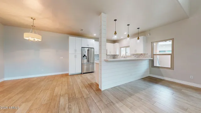 a view of a kitchen with wooden floor