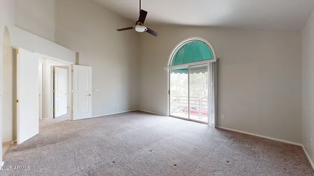 an empty room with windows dryer and a chandelier