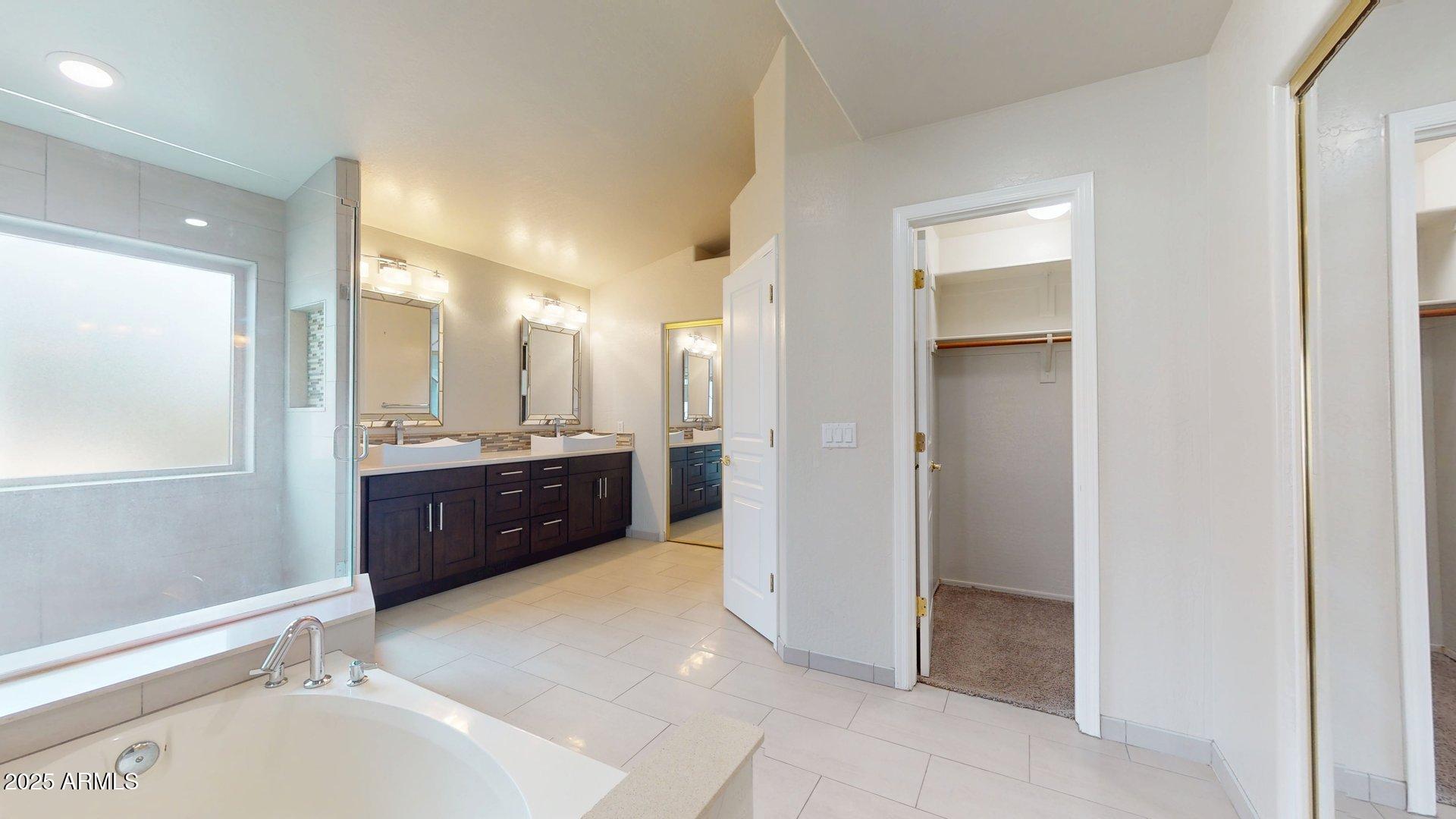 6510 South Hazelton Lane, Unit 142 Tempe, AZ 85283 - Photo 26 of 49 a spacious bathroom with a mirror a sink and a mirror