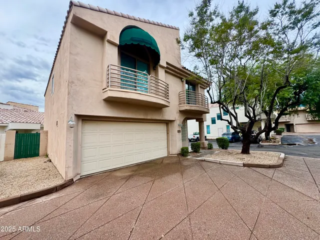 a view of the house with a yard and garage