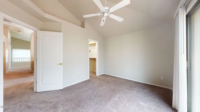 an empty room with fan and a ceiling fan