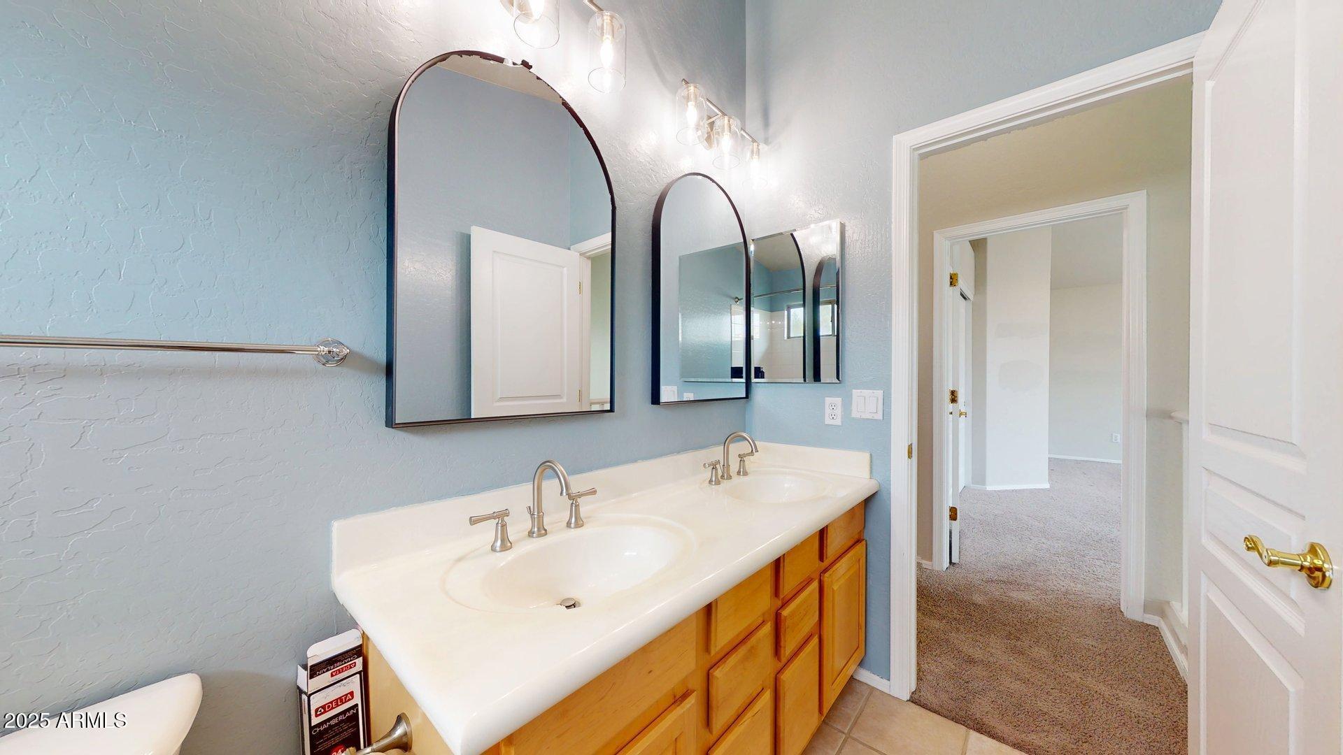 6510 South Hazelton Lane, Unit 142 Tempe, AZ 85283 - Photo 39 of 49 a en suite bathroom with a double vanity sink and a mirror