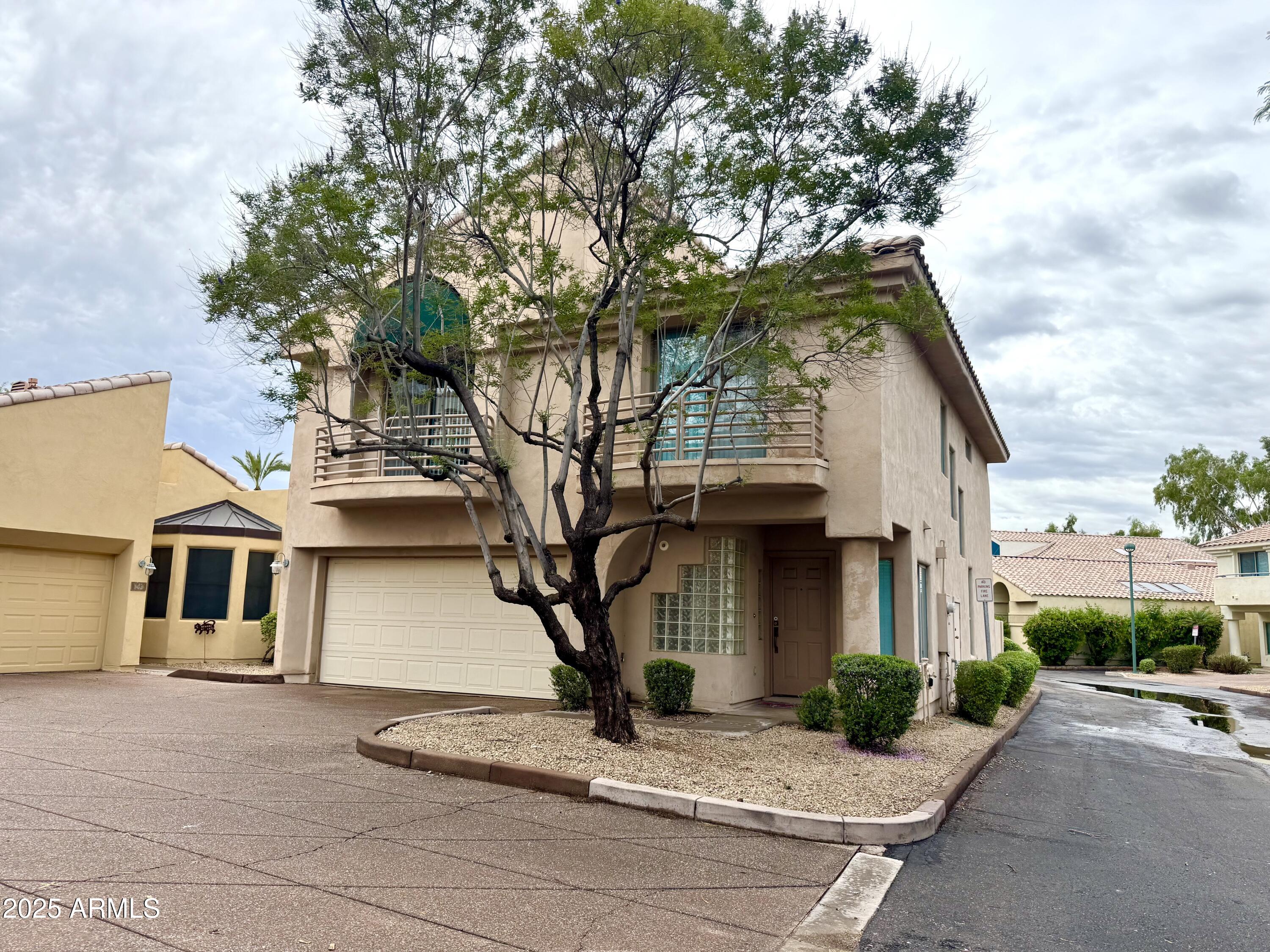 6510 South Hazelton Lane, Unit 142 Tempe, AZ 85283 - Photo 4 of 49 a front view of a house with a tree
