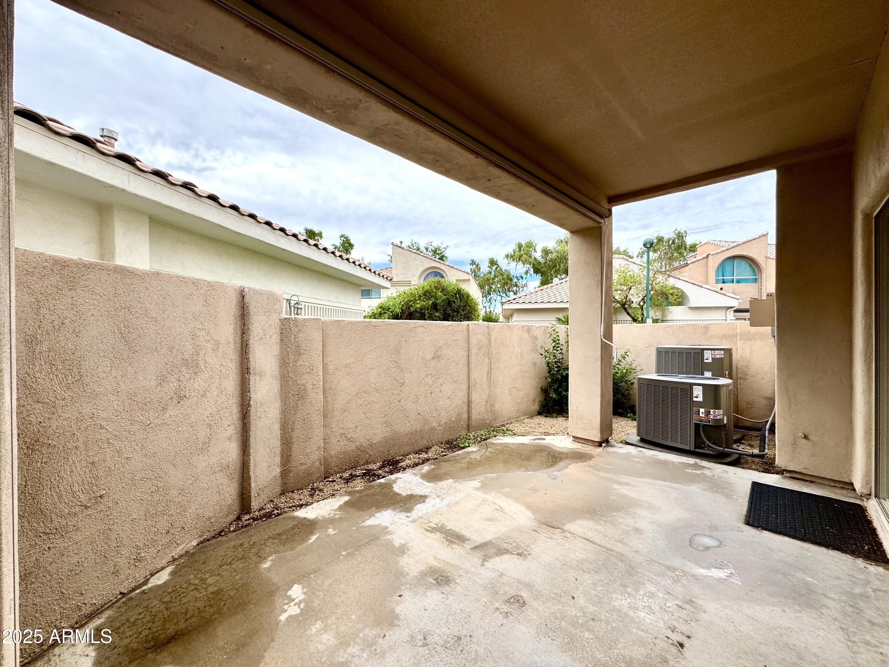 6510 South Hazelton Lane, Unit 142 Tempe, AZ 85283 - Photo 42 of 49 a view of backyard with a large window and wooden fence