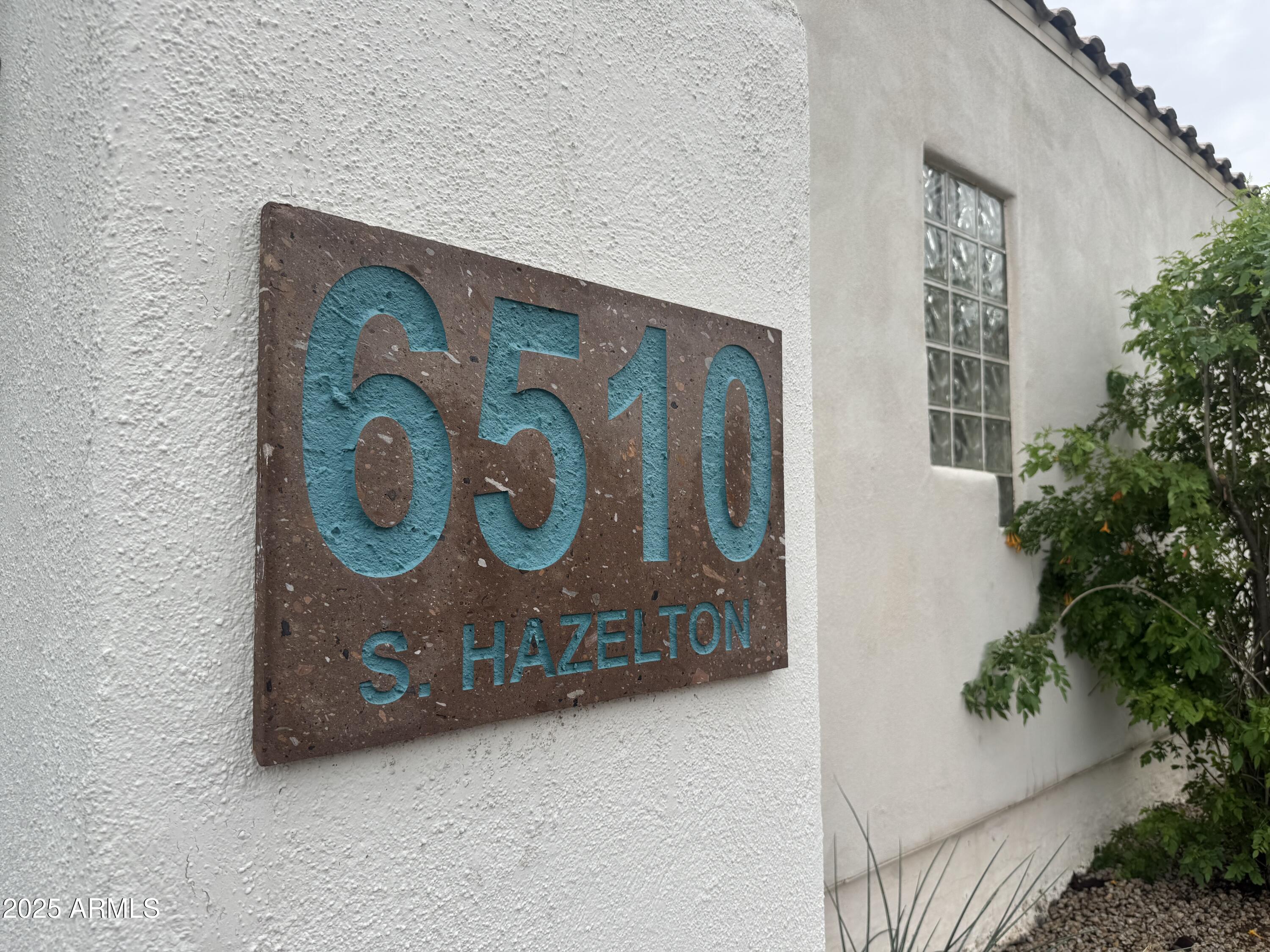 6510 South Hazelton Lane, Unit 142 Tempe, AZ 85283 - Photo 47 of 49 a wooden bench sitting in front of flowers
