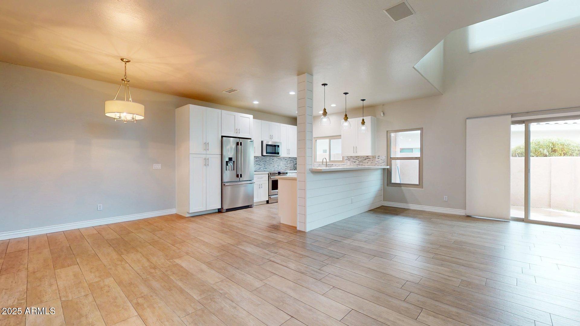 6510 South Hazelton Lane, Unit 142 Tempe, AZ 85283 - Photo 5 of 49 a view of a kitchen with wooden floor and a kitchen