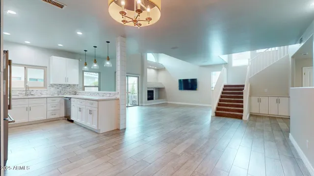 a kitchen with wooden floors and white cabinets