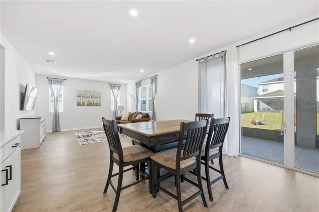 a view of a dining room with furniture and a potted plant