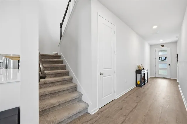 a view of an entryway with wooden floor