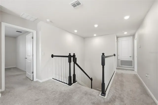 a view of a hallway with chandelier