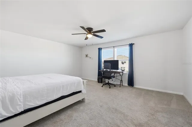 a bed room with a bed and a chair