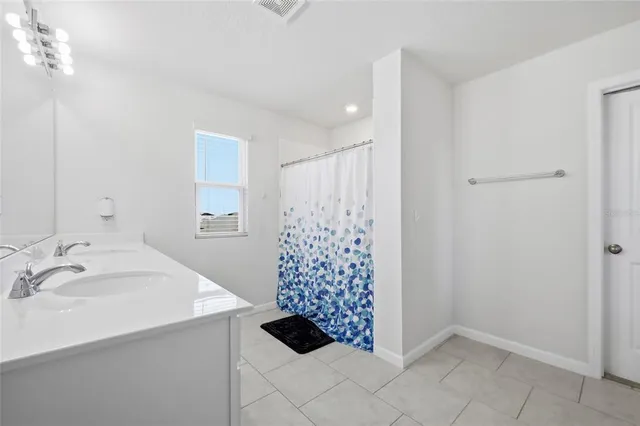 a bathroom with a shower and a sink
