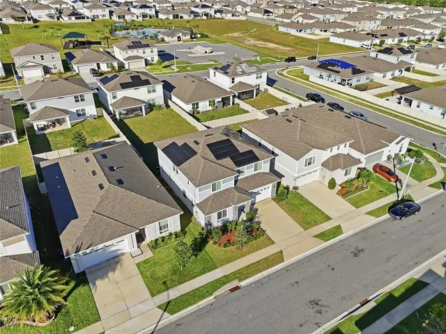 an aerial view of residential houses with outdoor space