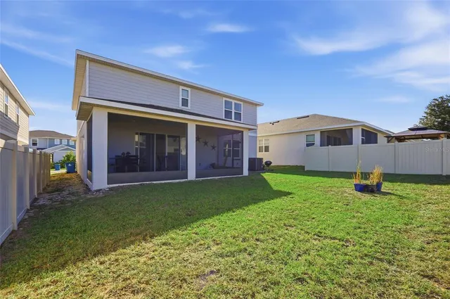a view of an house with backyard and porch