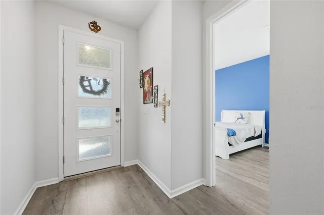 a view of an entryway with wooden floor