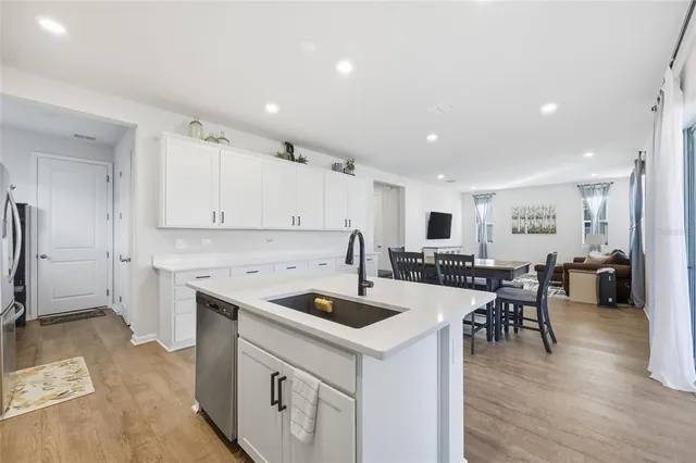a kitchen with a stove a refrigerator and a dining table