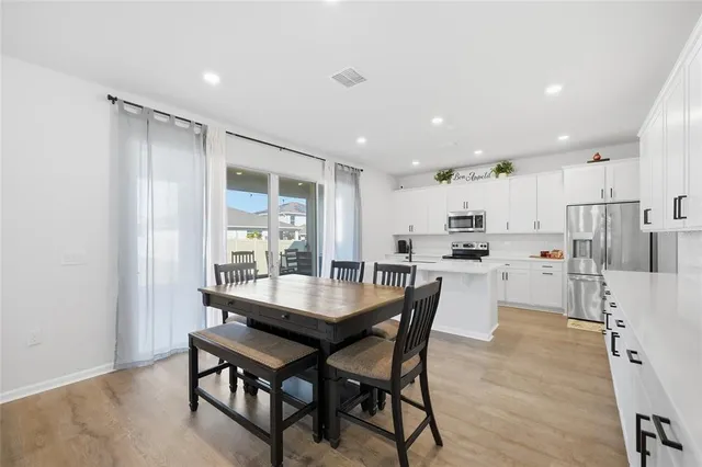a dining room with furniture and window