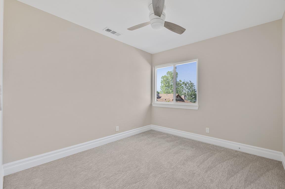 Cero Drive Santa Clarita, CA 91350 - Photo 11 of 45 an empty room with windows and ceiling fan