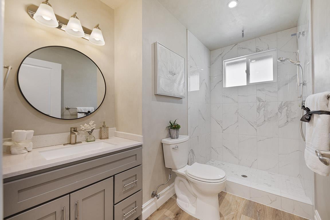 Cero Drive Santa Clarita, CA 91350 - Photo 13 of 45 a bathroom with a sink a toilet and a mirror