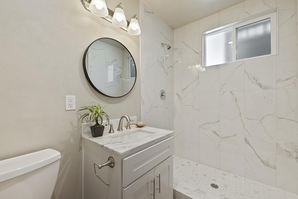 Cero Drive Santa Clarita, CA 91350 - Photo 25 of 45 a bathroom with a sink a toilet and a mirror
