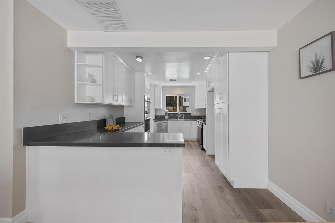 Cero Drive Santa Clarita, CA 91350 - Photo 32 of 45 a kitchen with stainless steel appliances granite countertop a refrigerator a sink and white cabinets