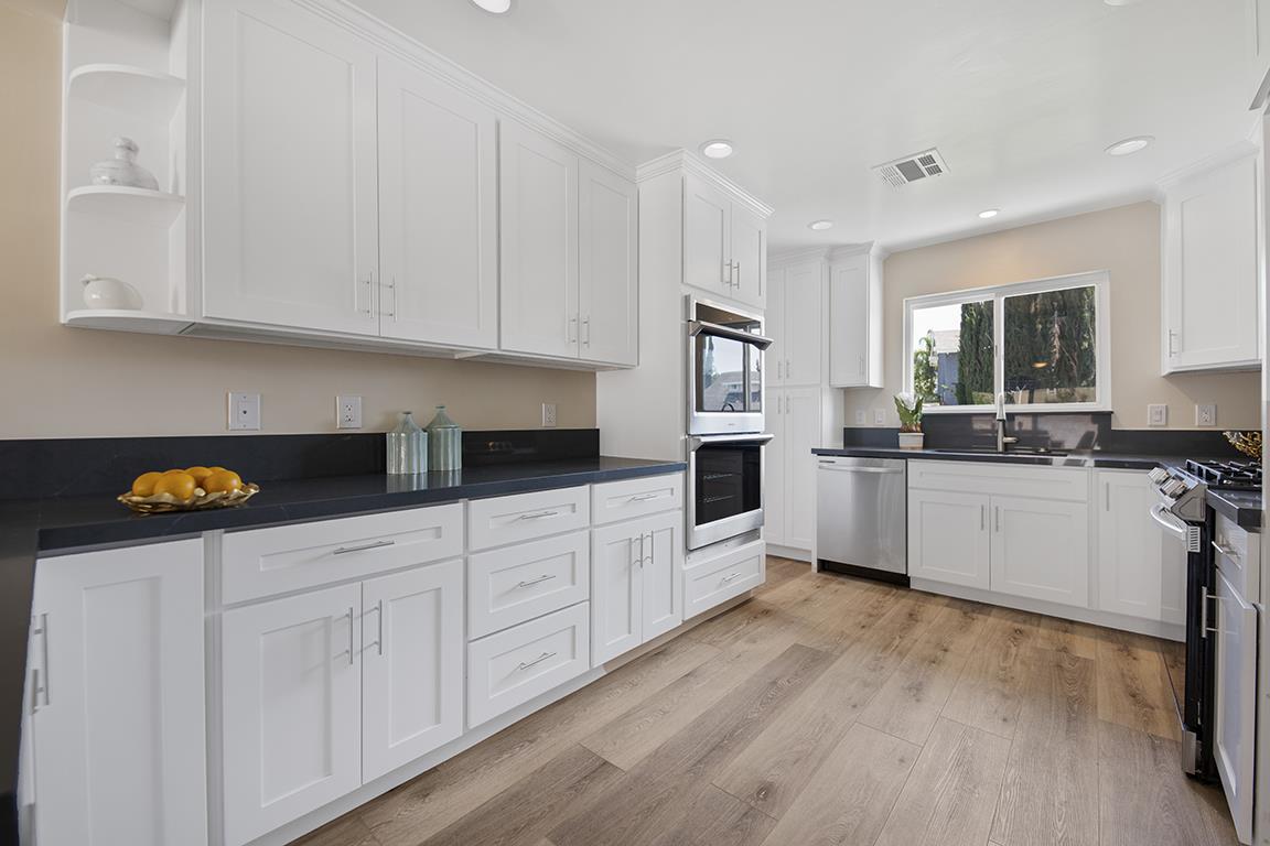 Cero Drive Santa Clarita, CA 91350 - Photo 33 of 45 a kitchen with granite countertop white cabinets and white appliances