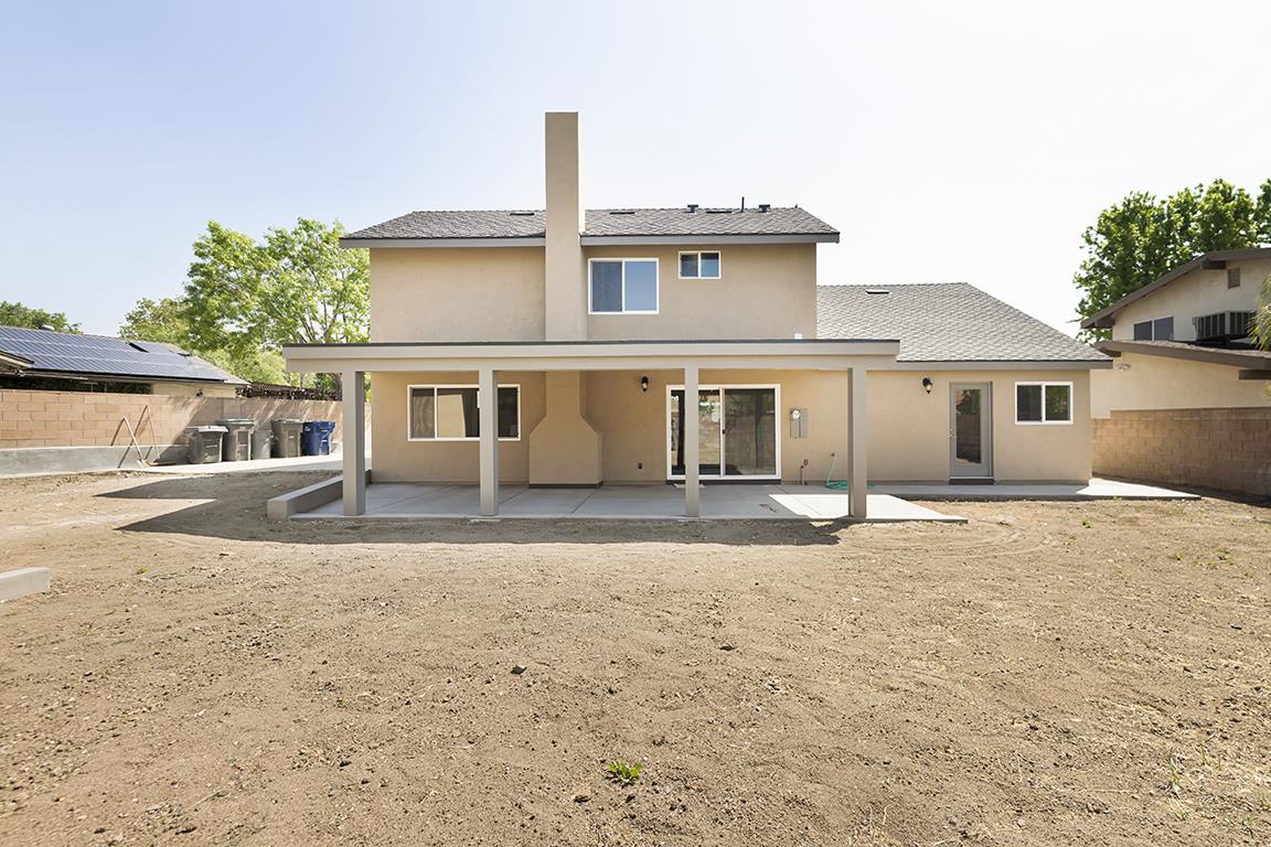 Cero Drive Santa Clarita, CA 91350 - Photo 42 of 45 a front view of a house with a yard and garage