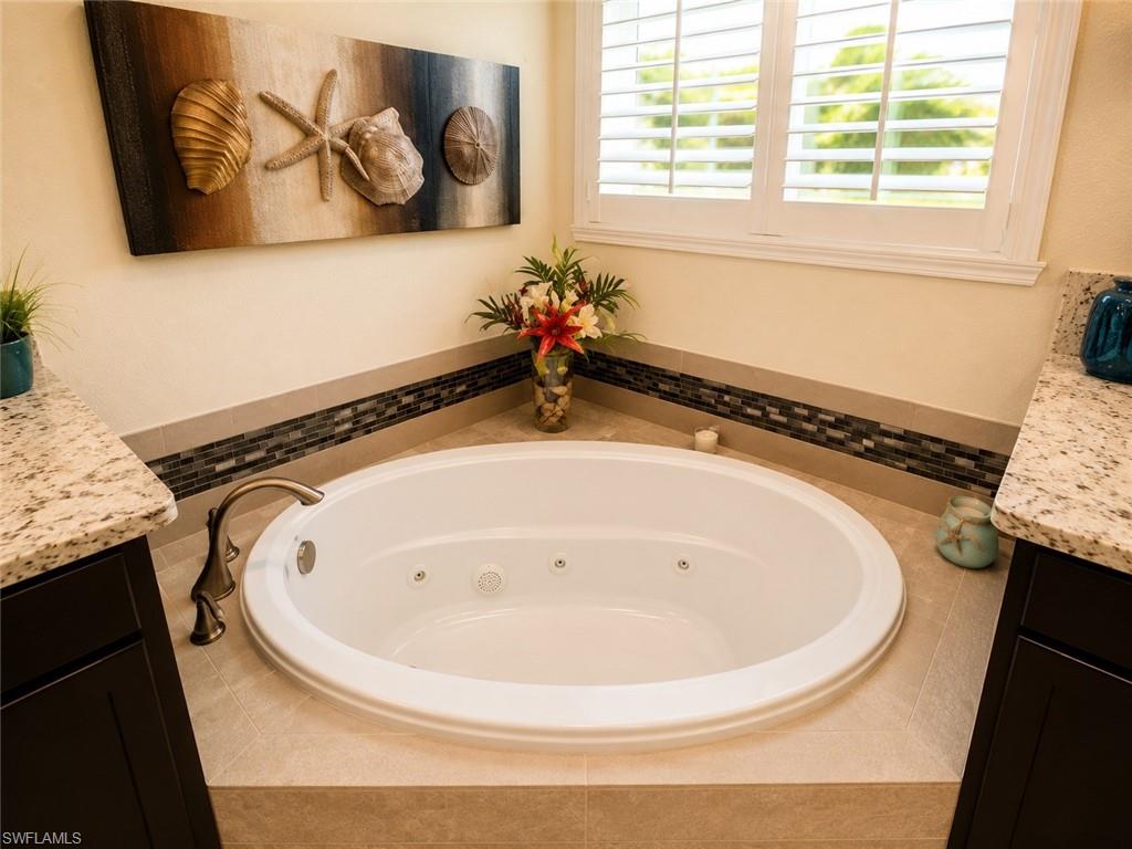 6574 Amarone Lane Naples, FL 34113 - Photo 23 of 44 a bathroom with a sink and a mirror