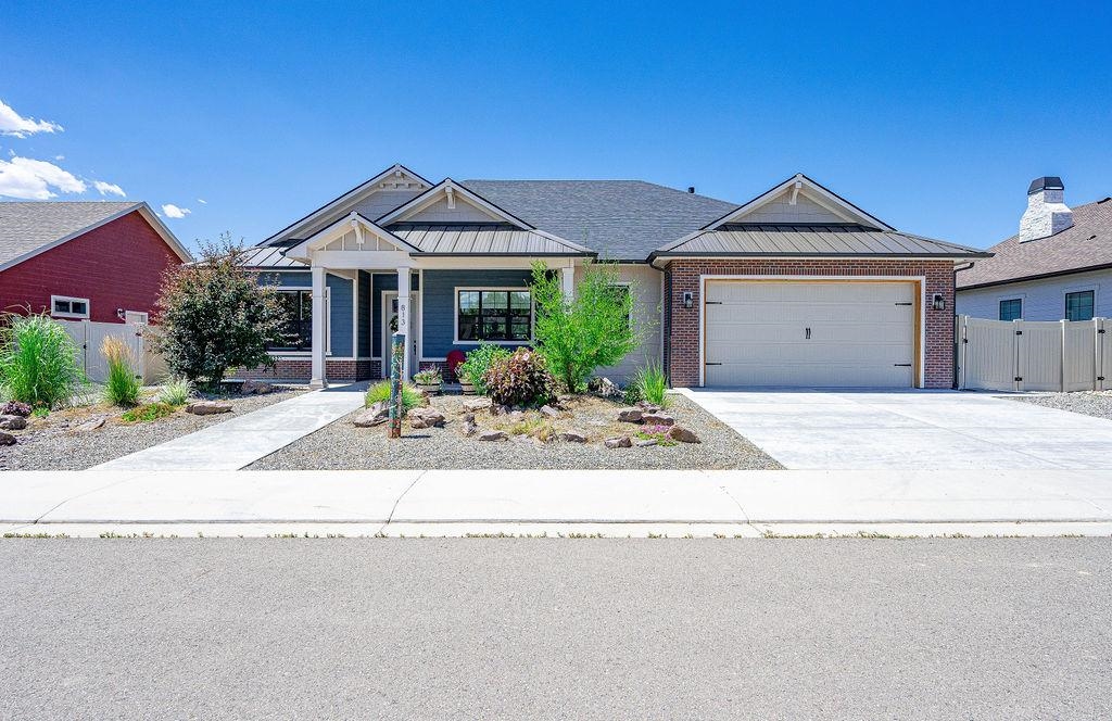 813 Red Apple Road Grand Junction, CO 81505 - Photo 1 of 30 a front view of a house with a yard and garage