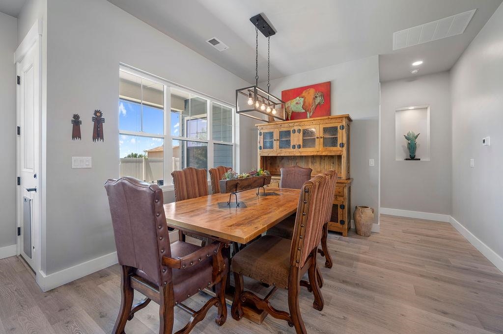 813 Red Apple Road Grand Junction, CO 81505 - Photo 12 of 30 a view of a dining room with furniture window and wooden floor