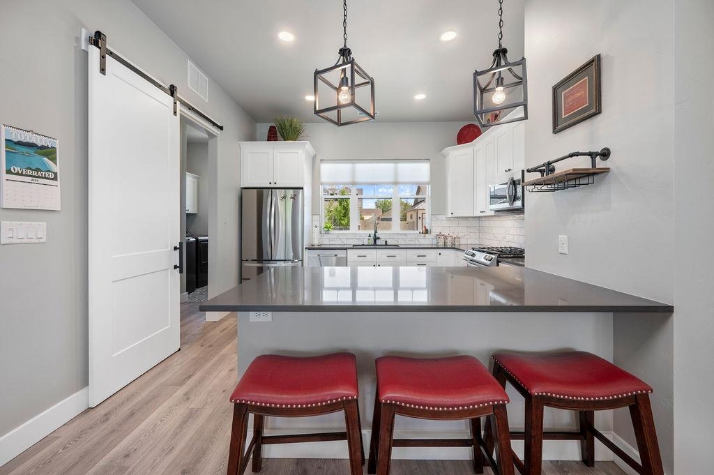 813 Red Apple Road Grand Junction, CO 81505 - Photo 14 of 30 a kitchen with stainless steel appliances a dining table chairs and wooden floor