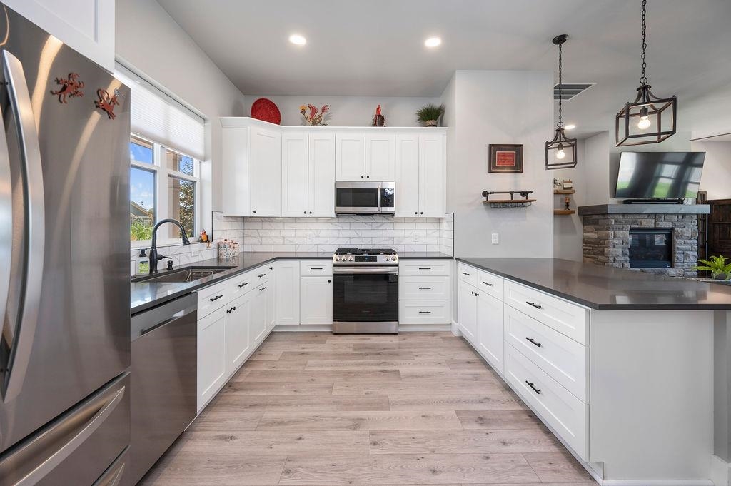 813 Red Apple Road Grand Junction, CO 81505 - Photo 16 of 30 a large kitchen with stainless steel appliances granite countertop a stove a sink and a refrigerator