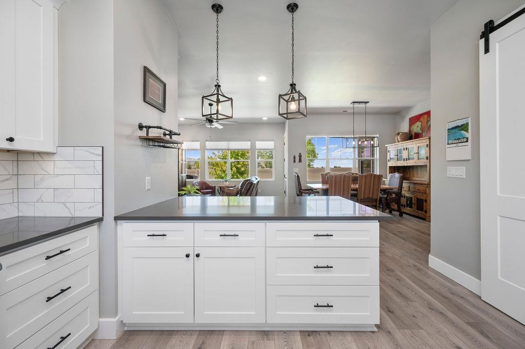 813 Red Apple Road Grand Junction, CO 81505 - Photo 17 of 30 a kitchen with white cabinets and center island