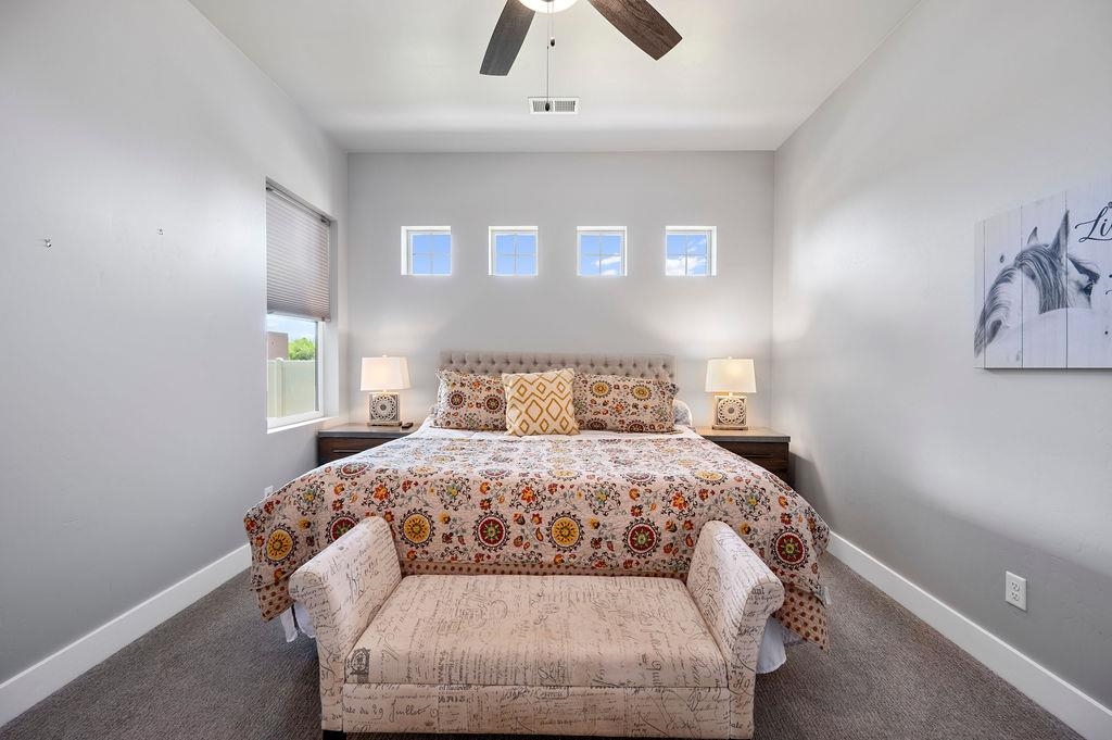 813 Red Apple Road Grand Junction, CO 81505 - Photo 20 of 30 a bedroom with a bed and a ceiling fan