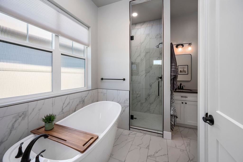 813 Red Apple Road Grand Junction, CO 81505 - Photo 24 of 30 a bathroom with a tub shower and mirror