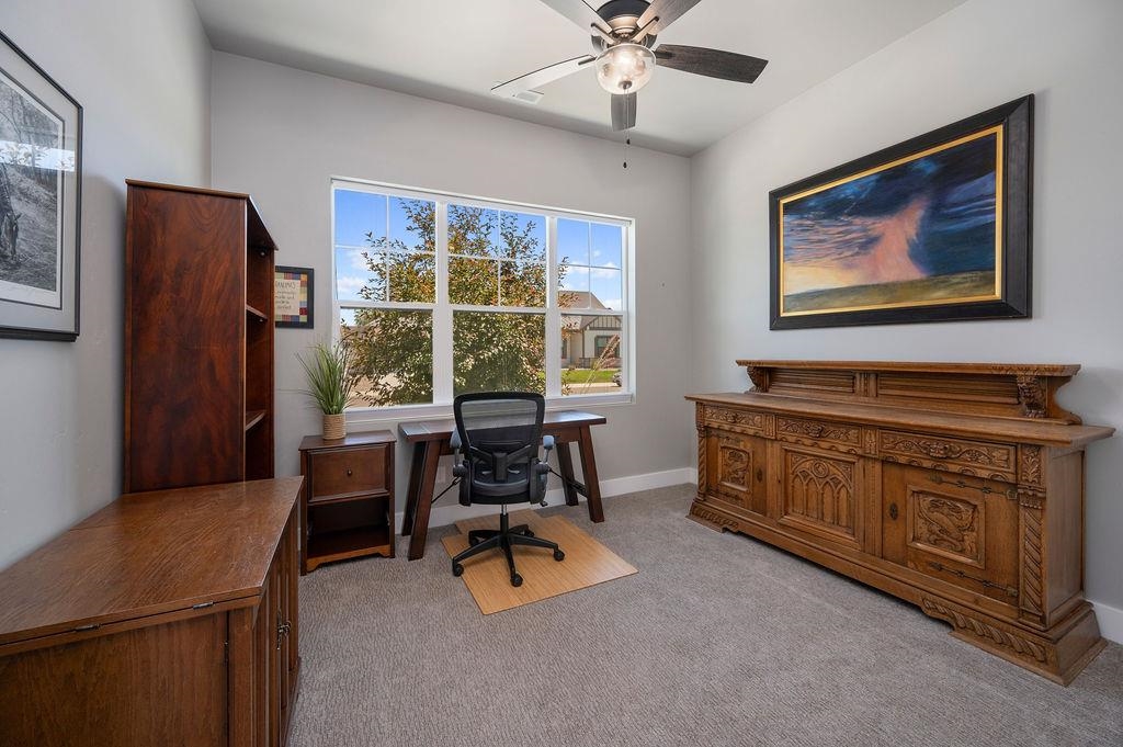 813 Red Apple Road Grand Junction, CO 81505 - Photo 26 of 30 a living room with furniture and a flat screen tv