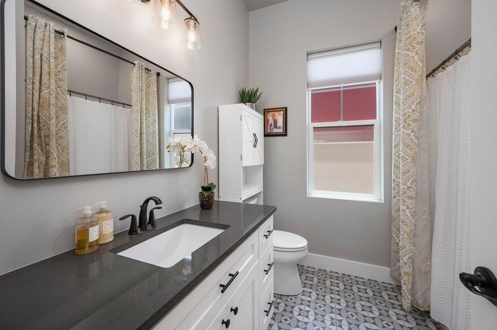 813 Red Apple Road Grand Junction, CO 81505 - Photo 28 of 30 a bathroom with a granite countertop sink toilet and shower