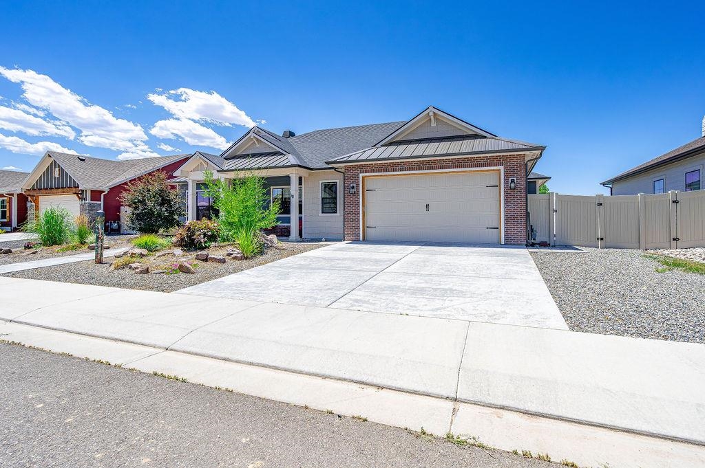 813 Red Apple Road Grand Junction, CO 81505 - Photo 3 of 30 a view of a house with a yard and potted plants