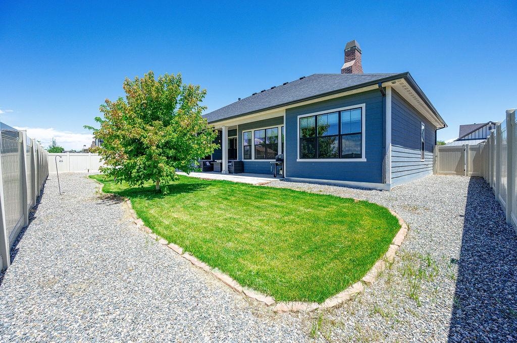 813 Red Apple Road Grand Junction, CO 81505 - Photo 4 of 30 a view of a house with a yard potted plants and a table