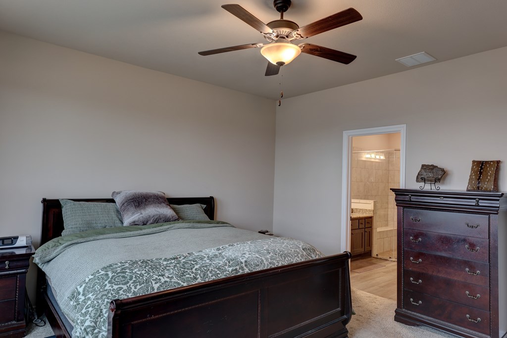 450 Jung Road Harper, TX 78631 - Photo 15 of 50 a bedroom with a bed and a dresser